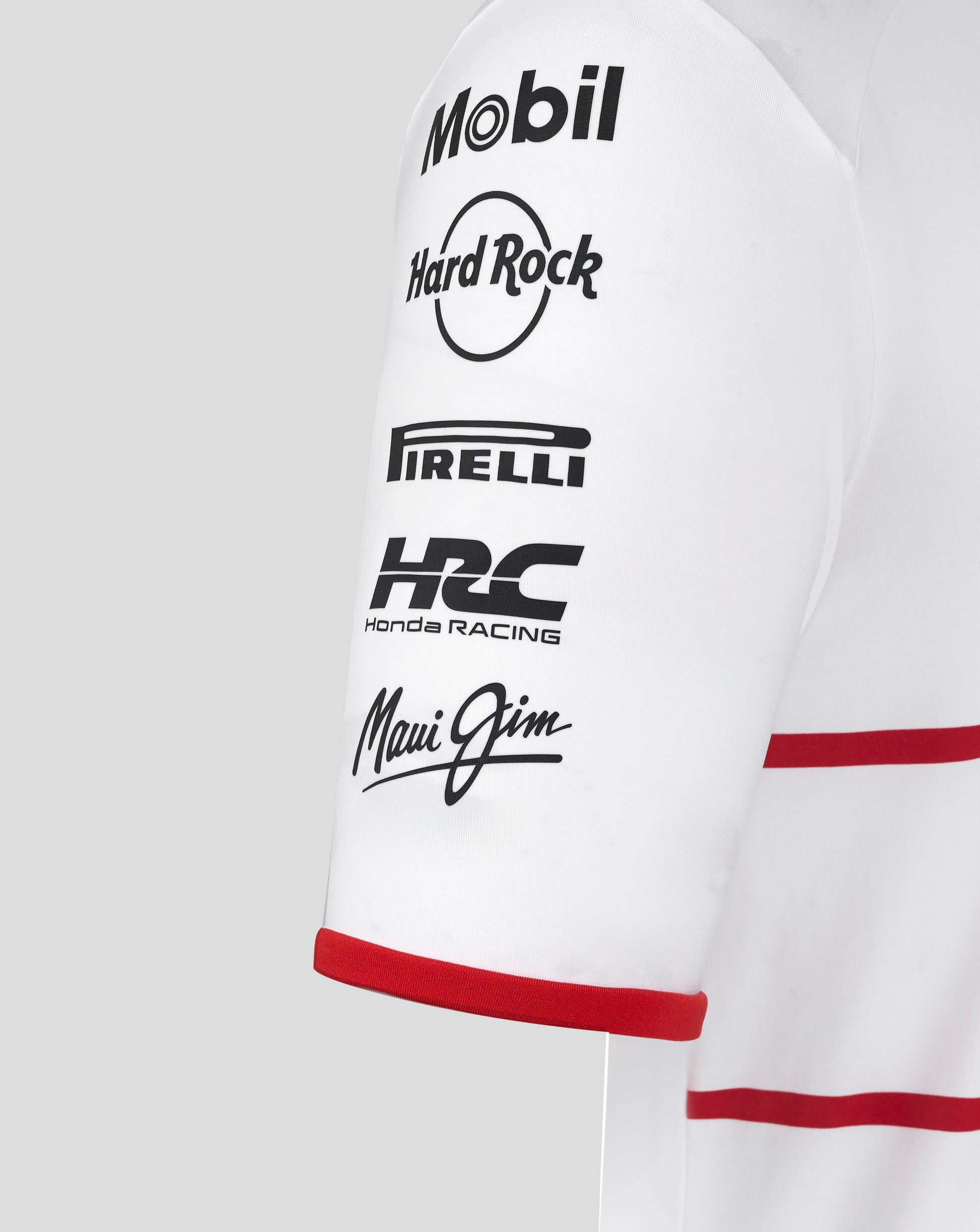 Sleeve close up on white Japan edition track polo featuring Mobil Hard Rock Pirelli Honda Racing Maui Jim logos
