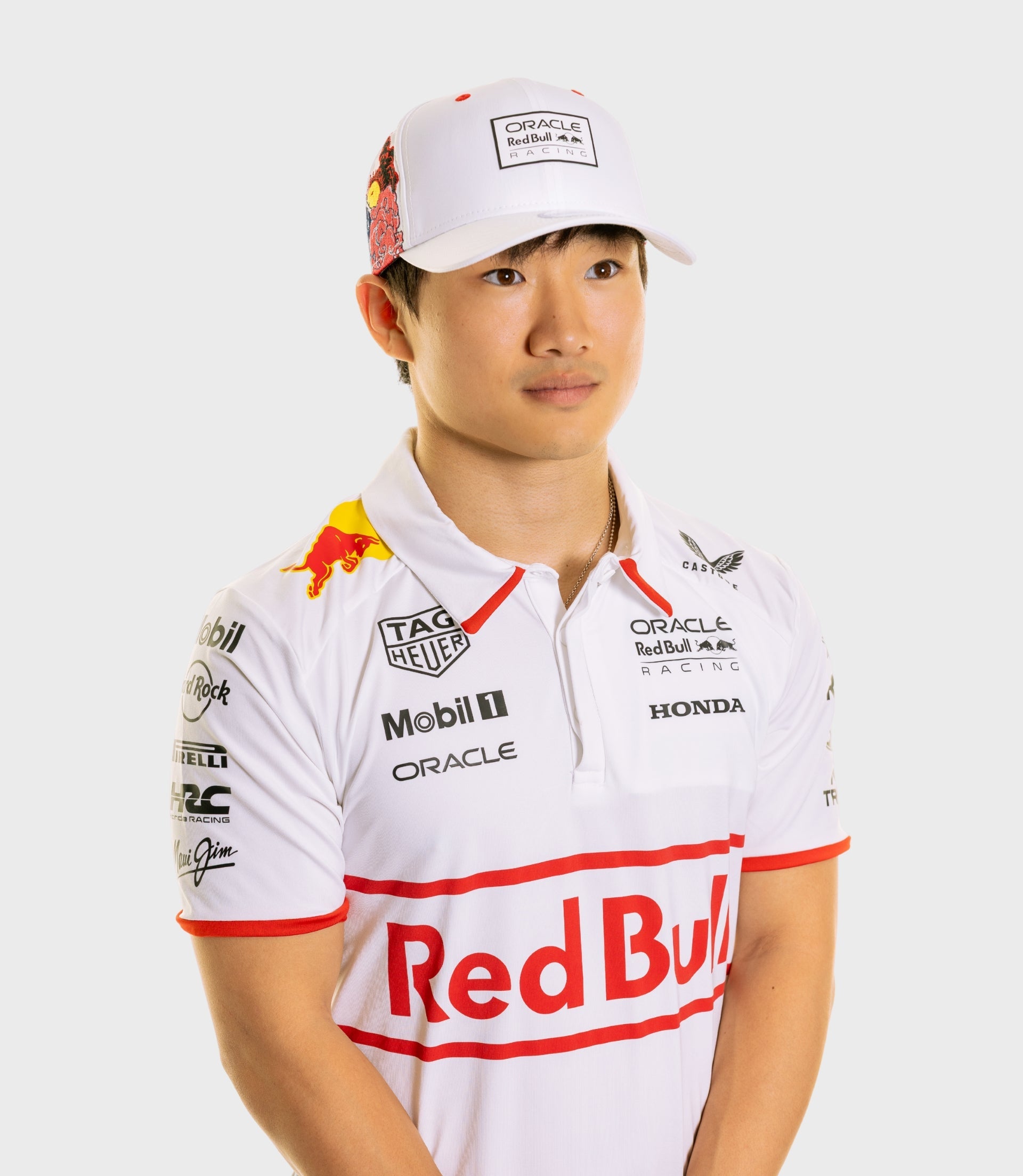 Portrait of a man wearing a white Oracle Red Bull Racing cap with a front logo patch and red floral side panel