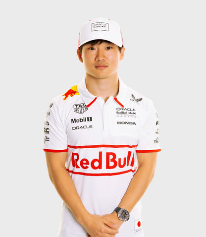 Close up of a man in a white Oracle Red Bull Racing Japan Special Track Polo with red trim and sponsor logos, wearing a wristwatch