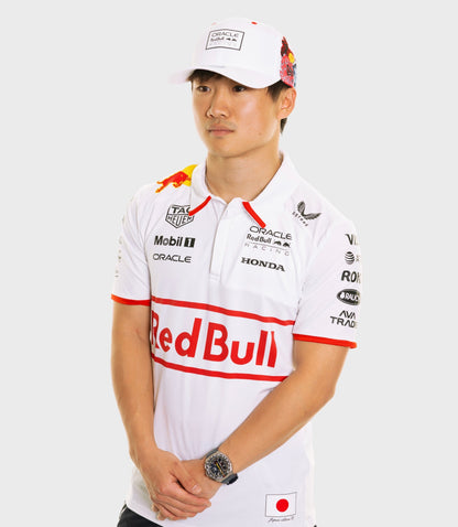 Male model in white Oracle Red Bull Racing Japan Special Track Polo with sponsor logos and a white cap.
