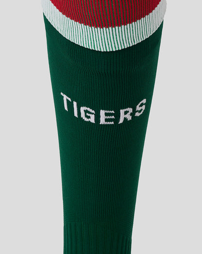 TIGERS lettering on the green Leicester Tigers sock with a calf view close-up.
