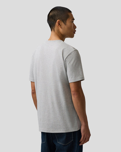Person wearing a gray t-shirt on a plain background