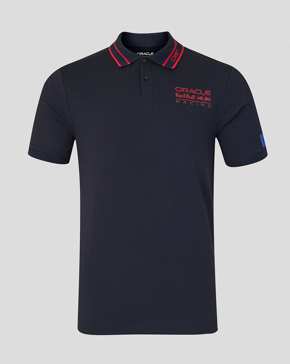 Navy polo shirt with red accents and branding on a gray background
