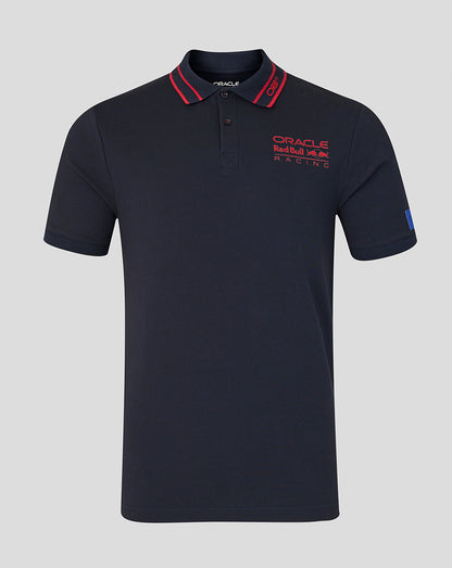 Navy polo shirt with red accents and branding on a gray background