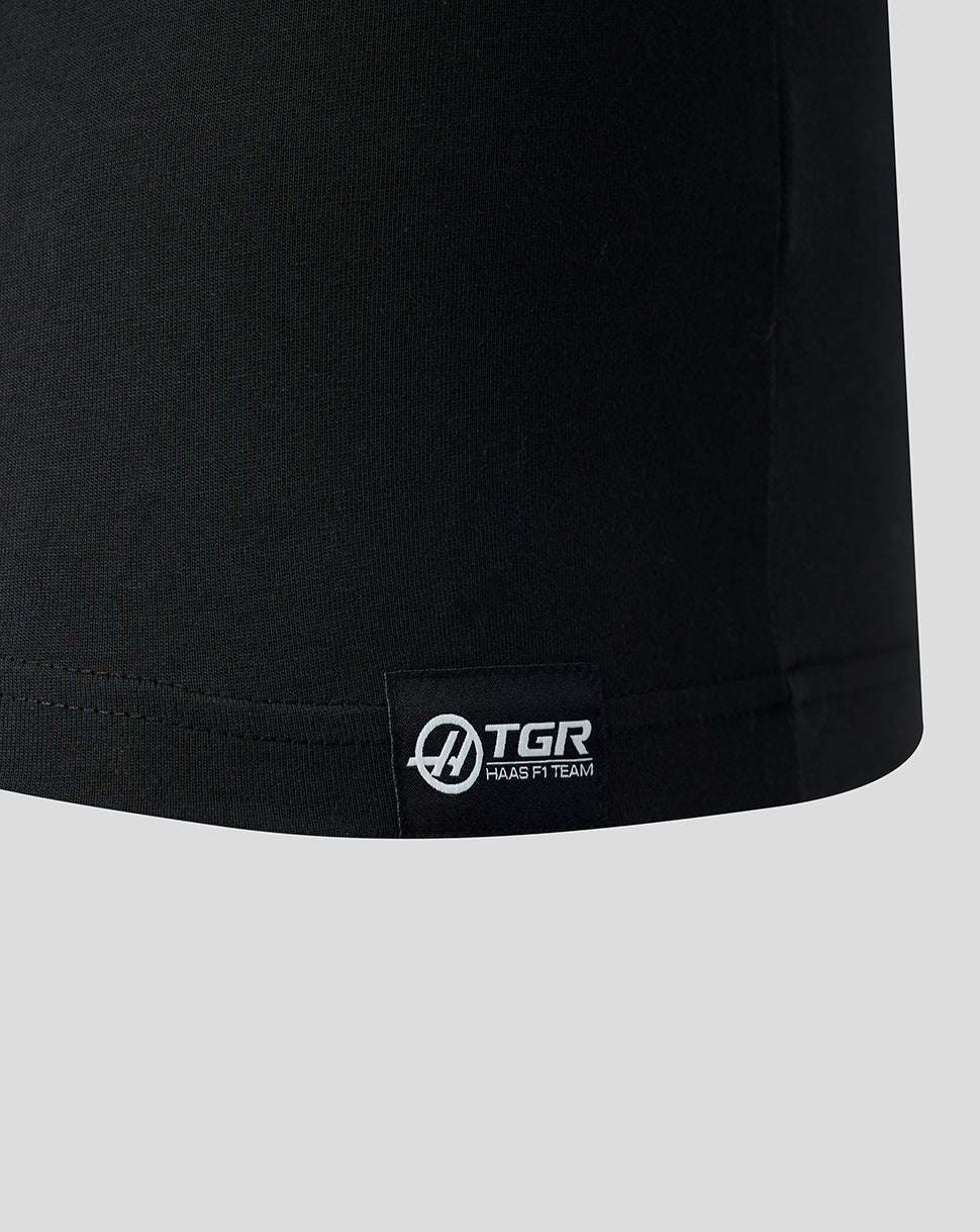Black t-shirt with a visible brand logo on a light gray background