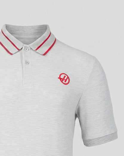 Gray polo shirt with red accents and a logo on a light gray background