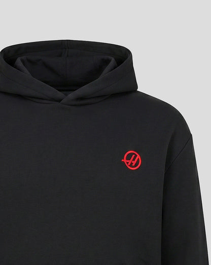 Black Haas Team hoodie close up with red circular monogram on chest and hood