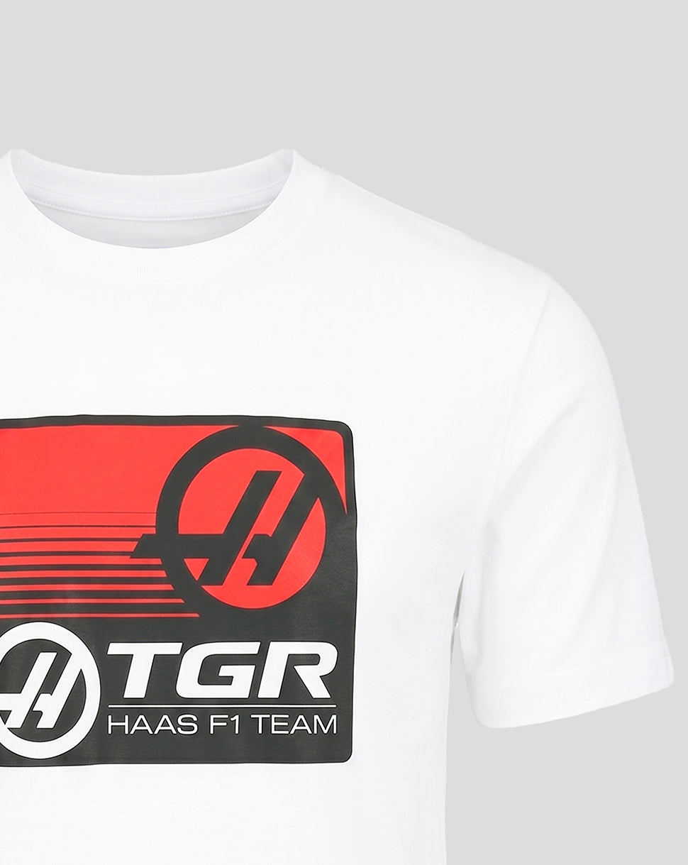 Close-up of the white Haas T-shirt showing the bold red and black front graphic with TGR Haas F1 Team branding