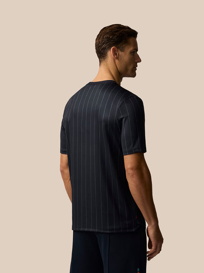 Back view of a male model wearing a dark pinstripe Paul Smith Castore England cricket unisex T-shirt