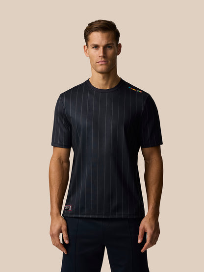 Man wearing navy striped Paul Smith Castore England cricket T shirt with shoulder stripe detail