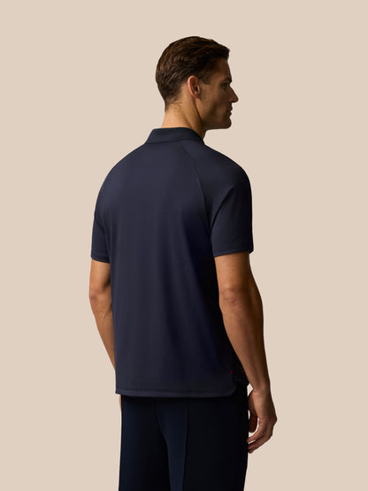 Rear view of navy Paul Smith Castore ECB Ashes polo on a male model highlighting knit fabric and cross over hem detail