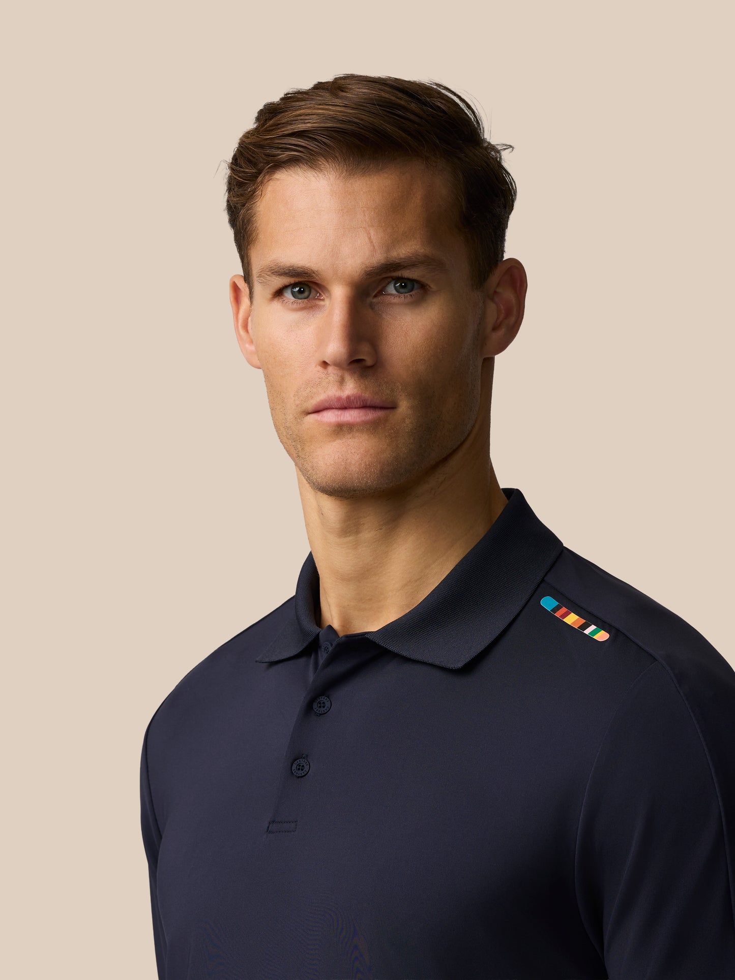 Male model wearing navy Paul Smith Castore England cricket polo with shoulder stripe detail