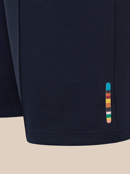 Close-up of navy England Cricket unisex shorts fabric with a colorful stripe tab