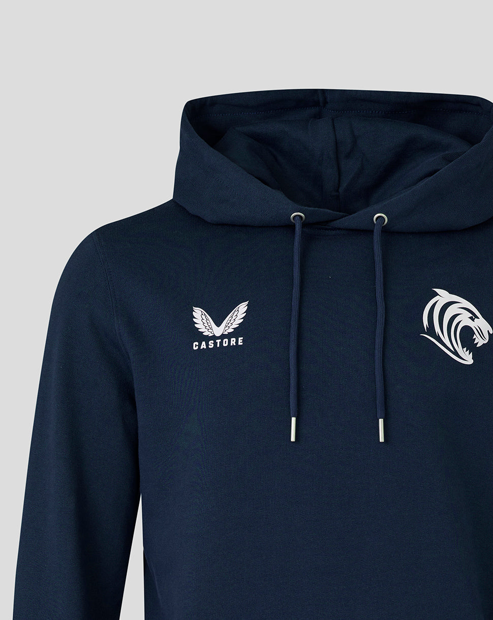 Close-up of navy hoodie chest area with tiger emblem on the right and Castore logo on the left, hood and drawstrings visible.