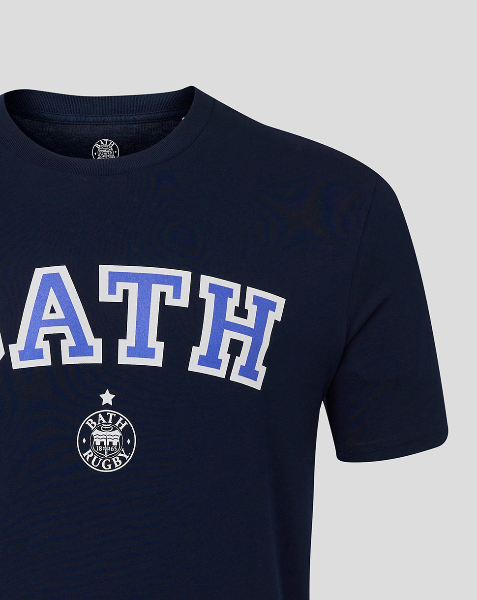 Close up of navy Bath Rugby tee showing bold BATH letters and small circular crest beneath