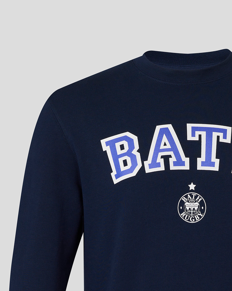 Detail view of navy Bath Rugby varsity crew sweatshirt showing large BATH lettering and chest emblem