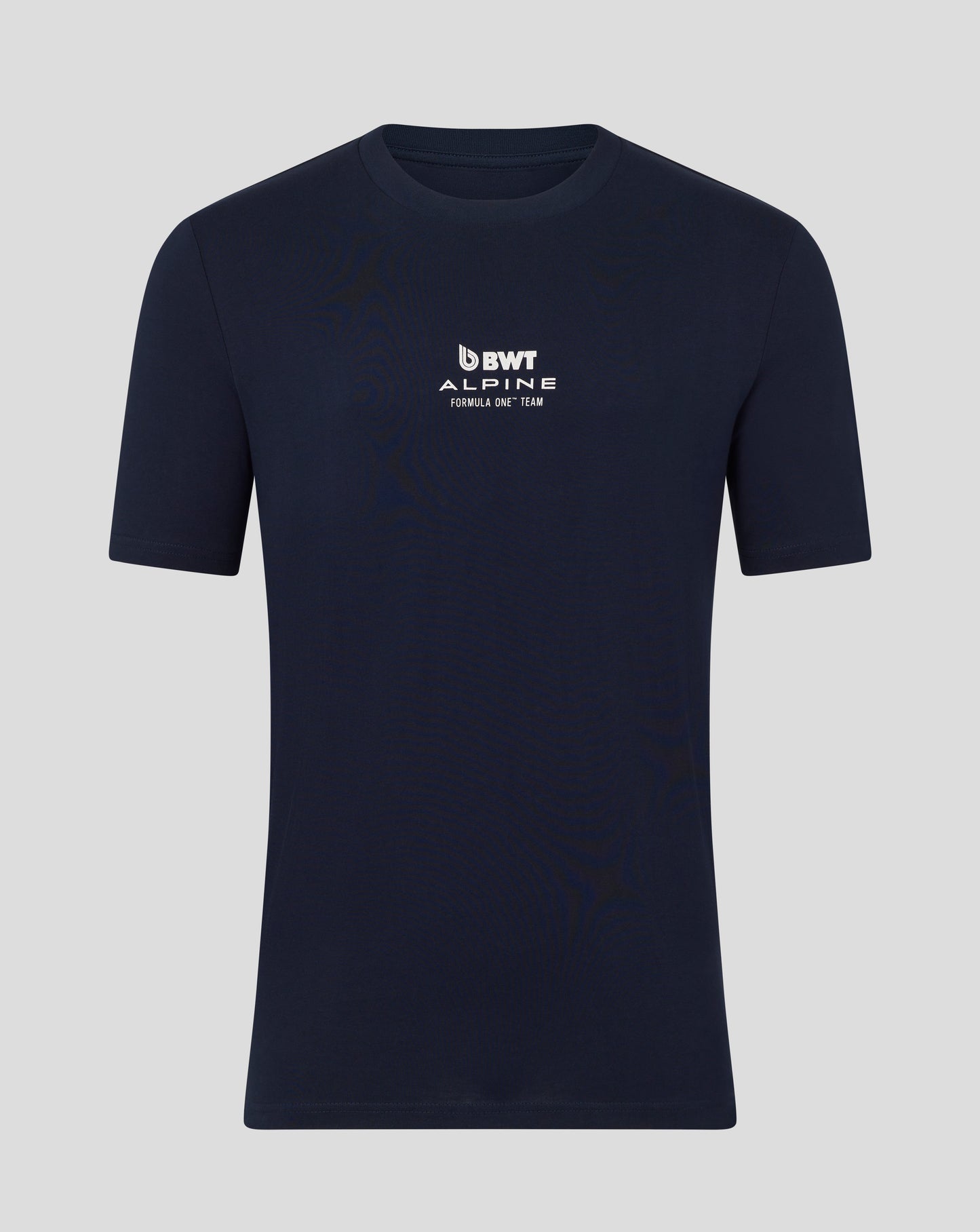 Man wearing a navy BWT Alpine T shirt with logo on the chest and arms crossed against a blue backdrop.