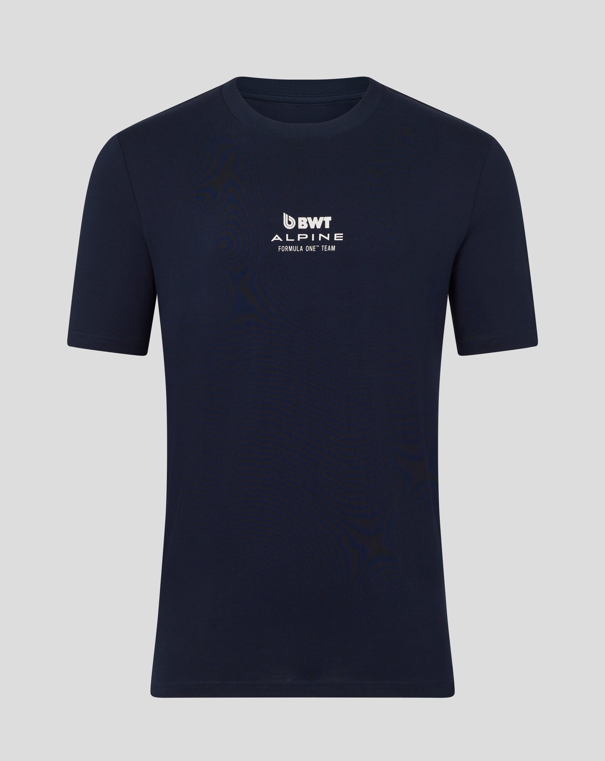 Man wearing a navy BWT Alpine T shirt with logo on the chest and arms crossed against a blue backdrop.