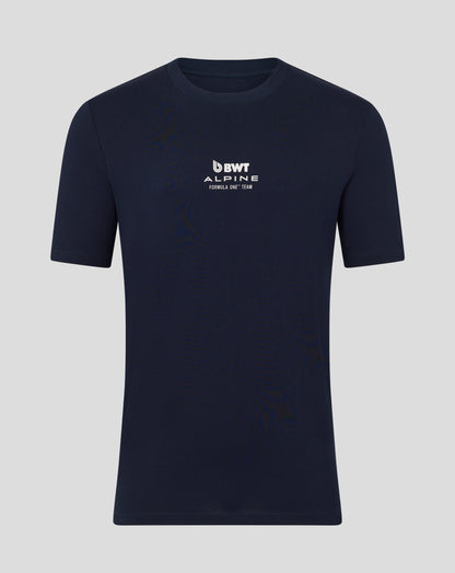 Man wearing a navy BWT Alpine T shirt with logo on the chest and arms crossed against a blue backdrop.