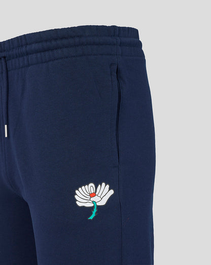 Navy blue sweatpants with a white embroidered flower design on a light gray background