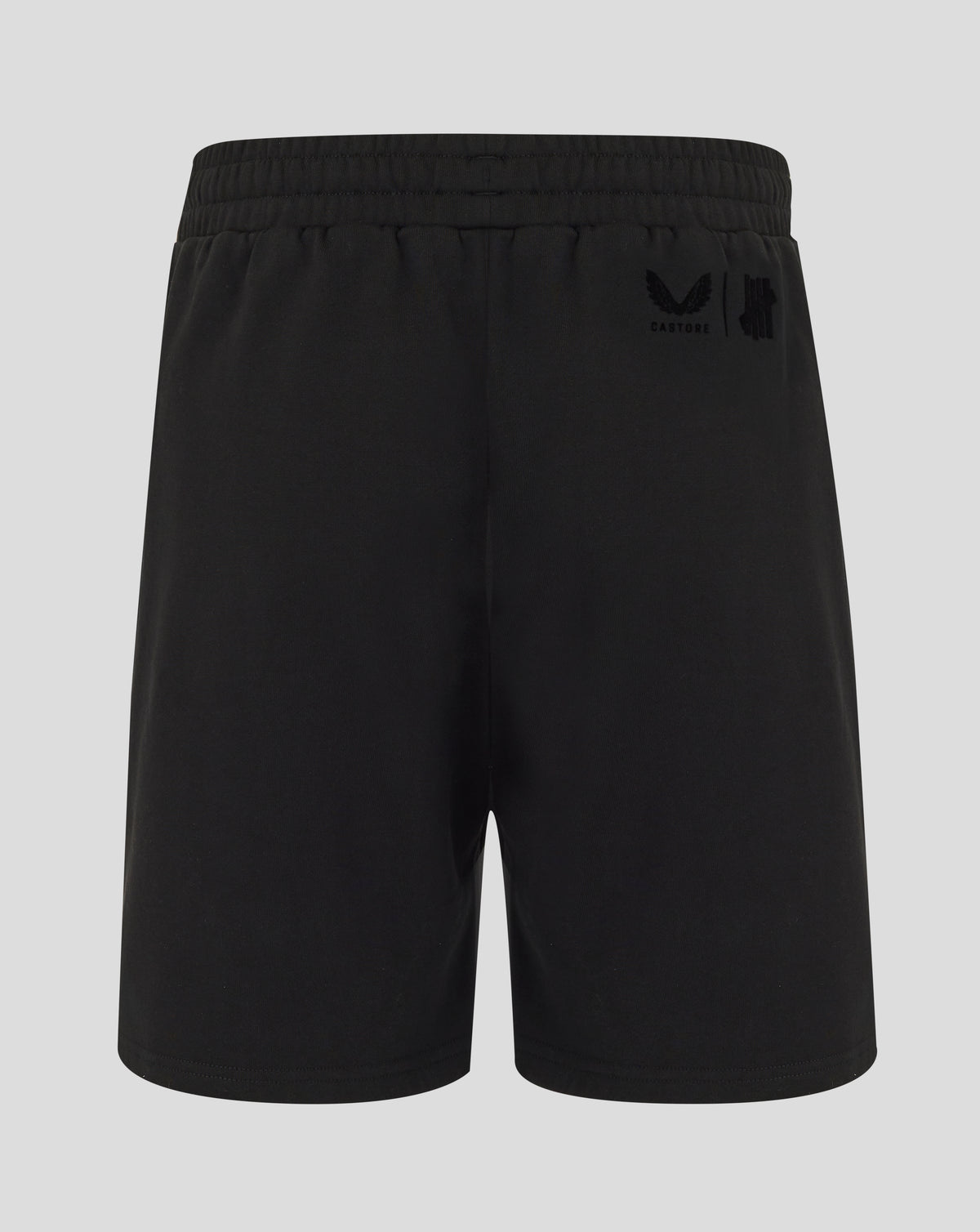Black shorts with a logo on the back pocket against a light gray background