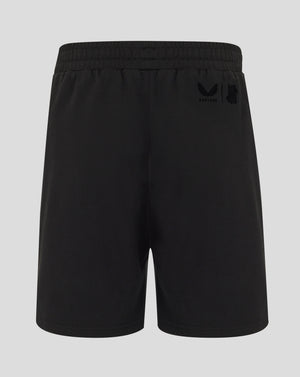 Black shorts with a logo on the back pocket against a light gray background