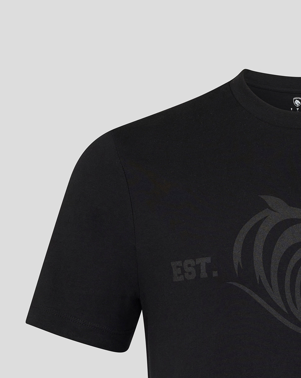 Close up of black tee showing a subtle dark grey tiger crest graphic across the chest.