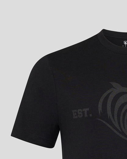 Close up of black tee showing a subtle dark grey tiger crest graphic across the chest.