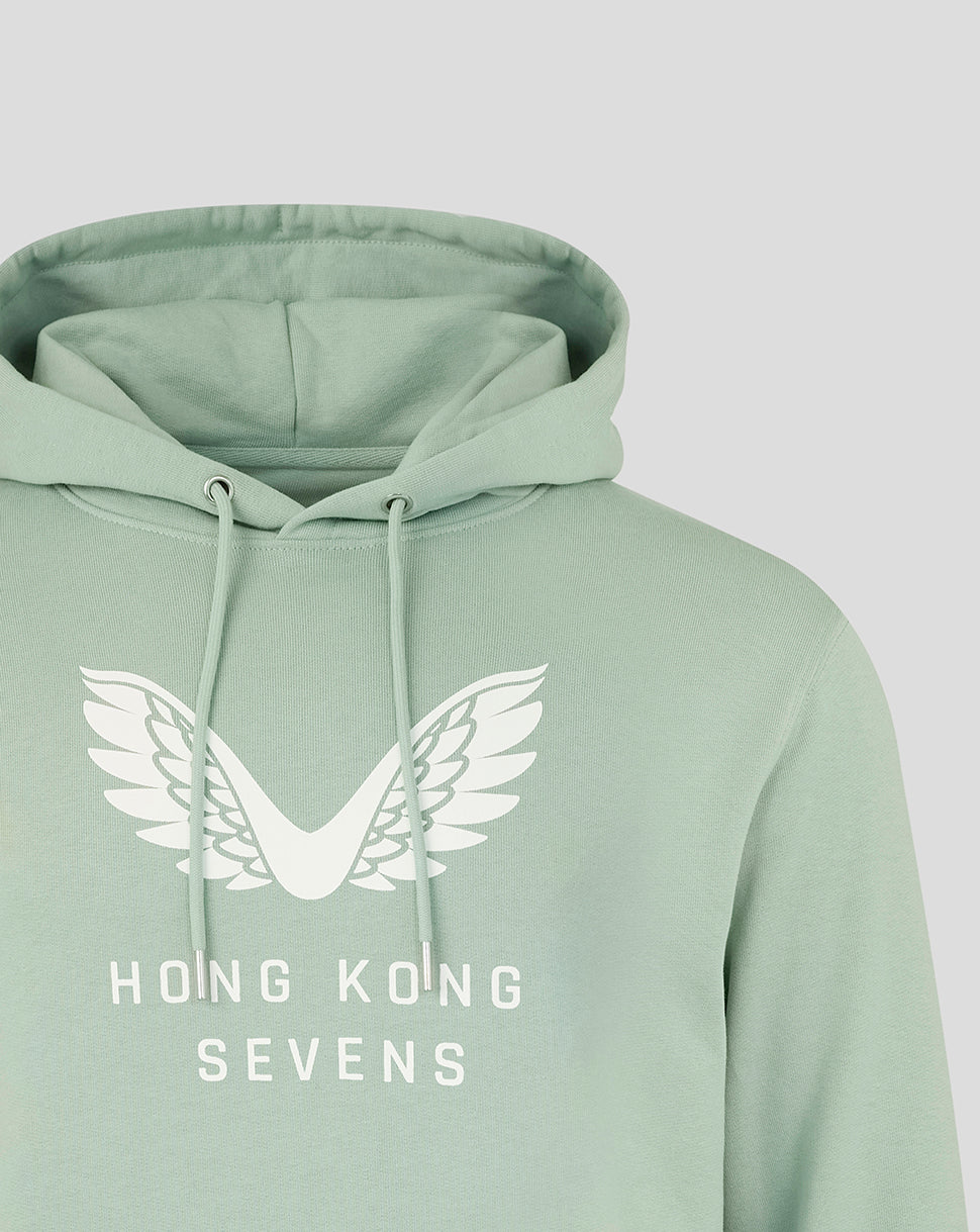 Close-up of pastel green unisex HK7s hoodie showing the white wing crest logo.