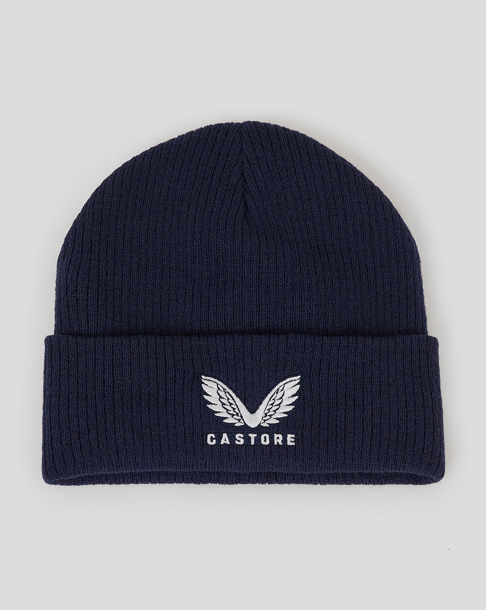 Peacoat blue ribbed knit beanie with fleece lining and Castore logo embroidery.