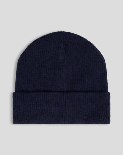 Navy ribbed knit beanie with folded cuff and white Castore logo embroidery.
