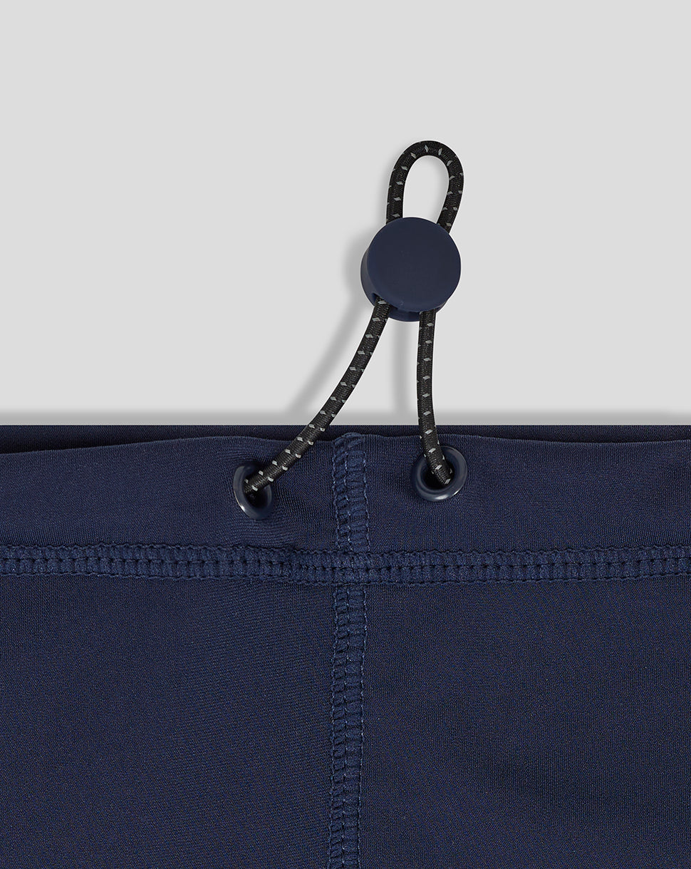 Close-up of navy snood showing cord with toggle threaded through eyelets