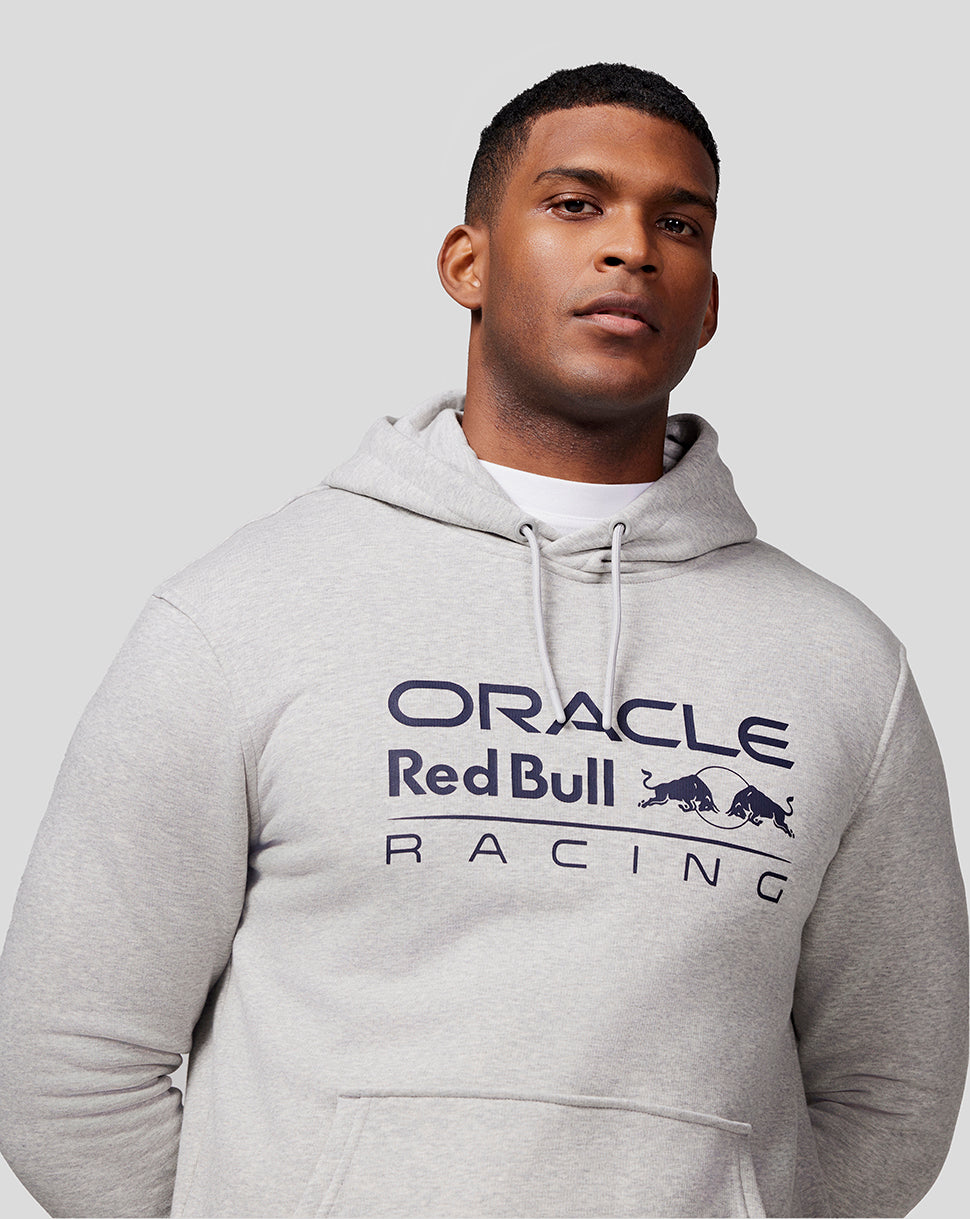 Male model wearing grey marl Unisex Core Overhead Hoodie with Mono Logo on chest and drawstring hood