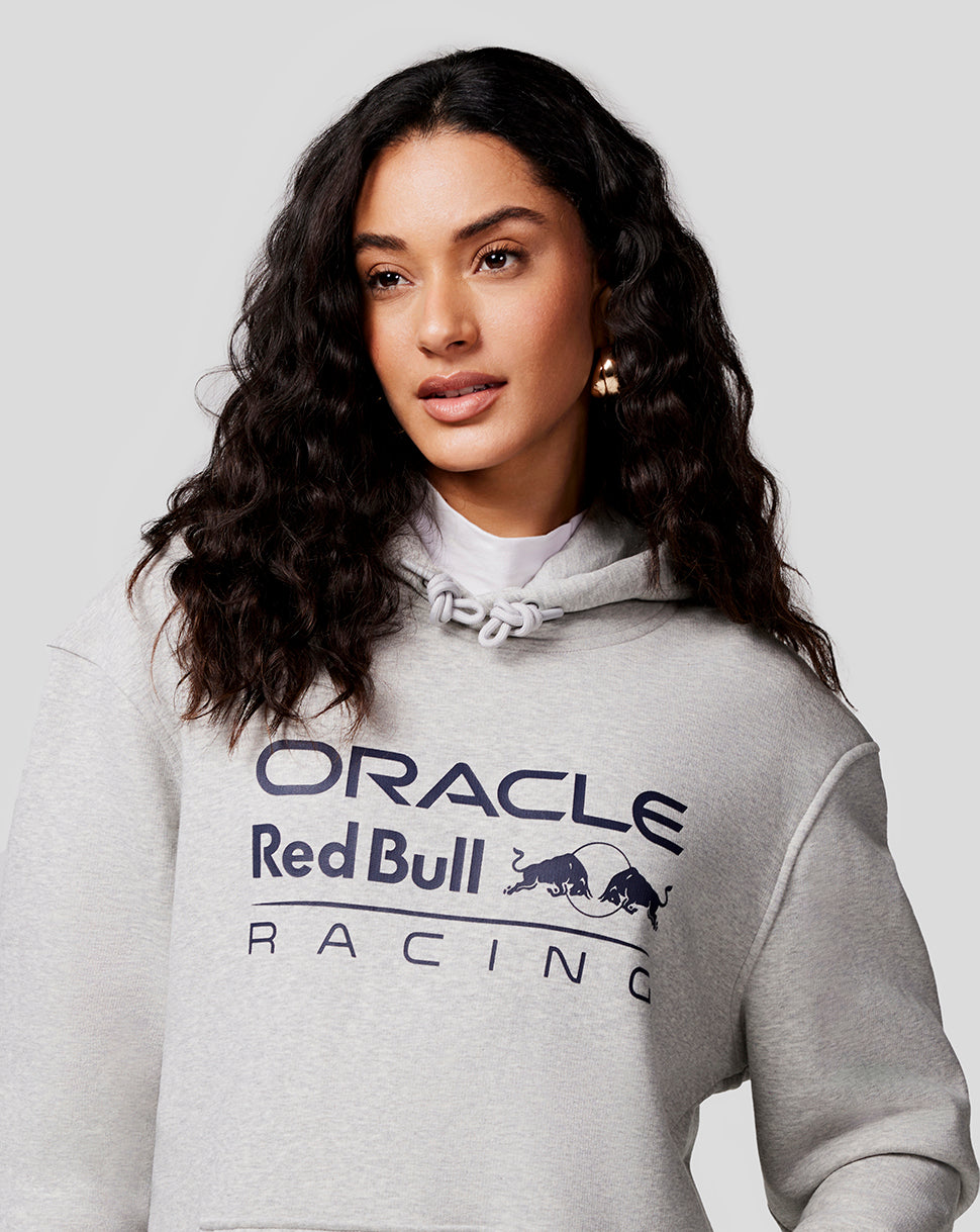 Female model wearing grey marl Unisex Core Overhead Hoodie with Mono Logo on chest