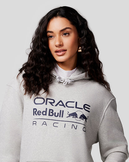 Female model wearing grey marl Unisex Core Overhead Hoodie with Mono Logo on chest