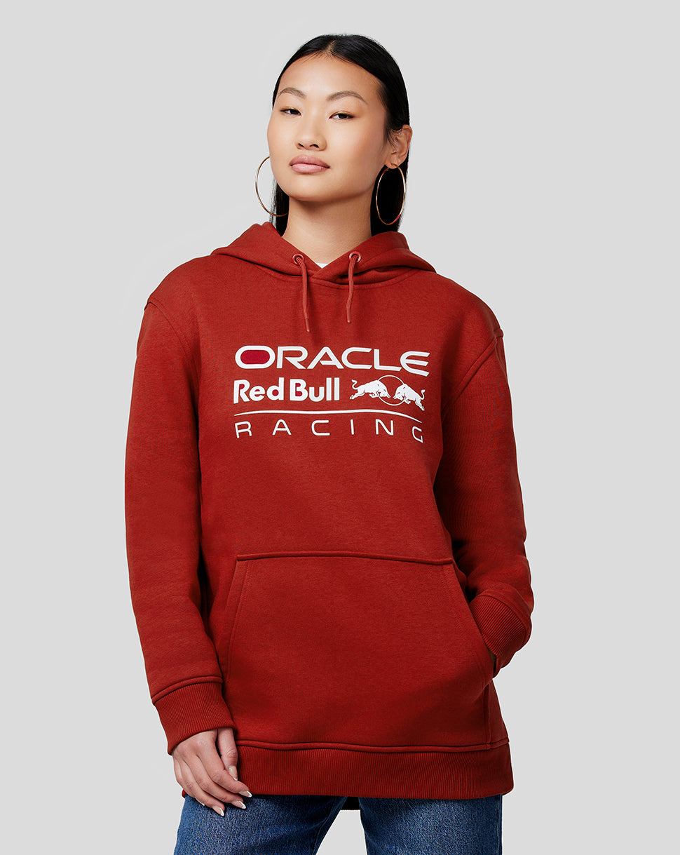 Person wearing Winery red Oracle Red Bull Racing unisex core overhead hoodie with white chest logo and kangaroo pocket.