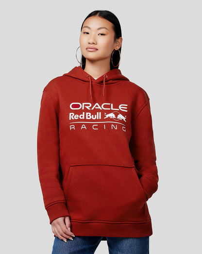 Person wearing Winery red Oracle Red Bull Racing unisex core overhead hoodie with white chest logo and kangaroo pocket.