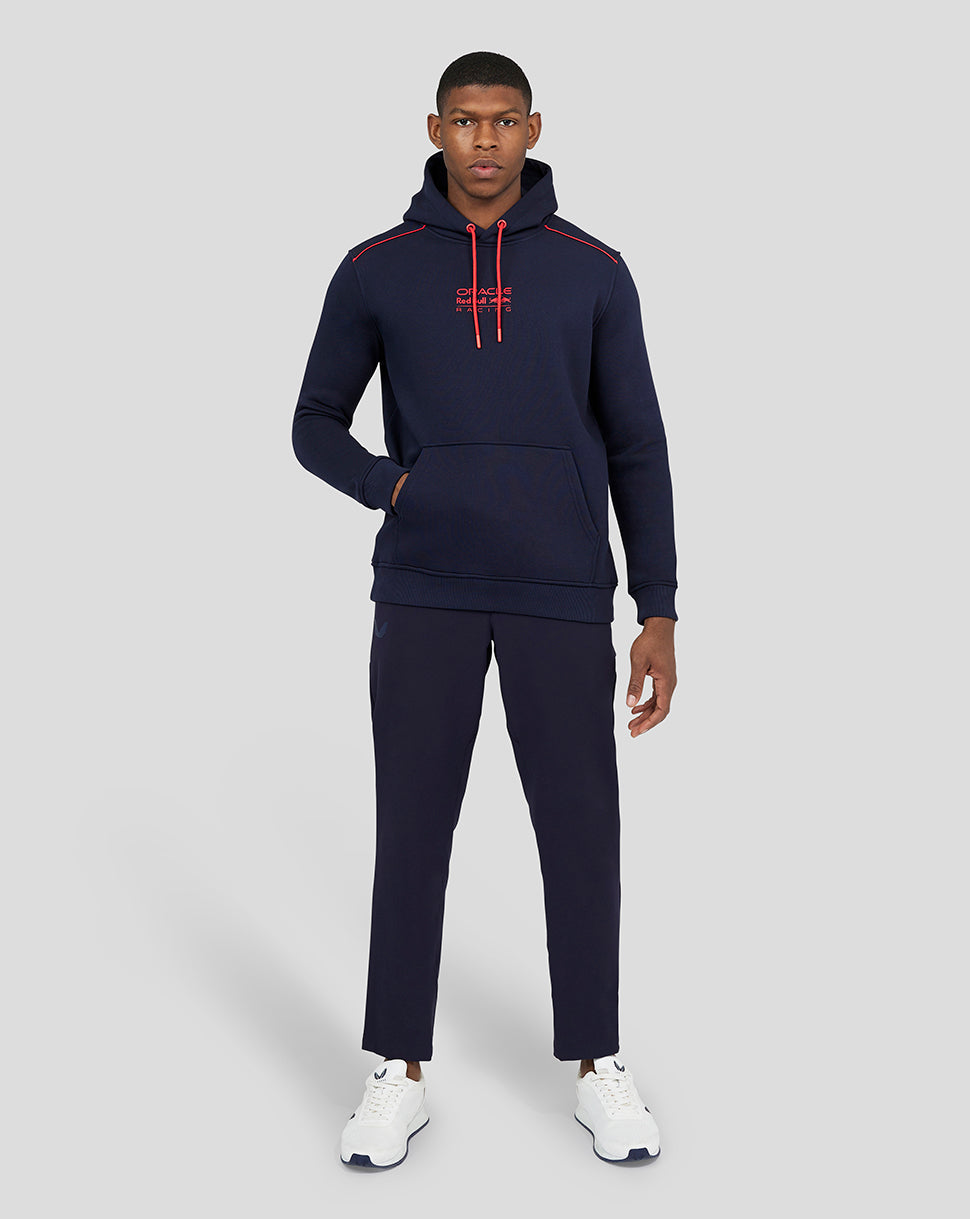 Front view of a man wearing a navy Oracle Red Bull Racing hoodie with red drawcords and a kangaroo pocket
