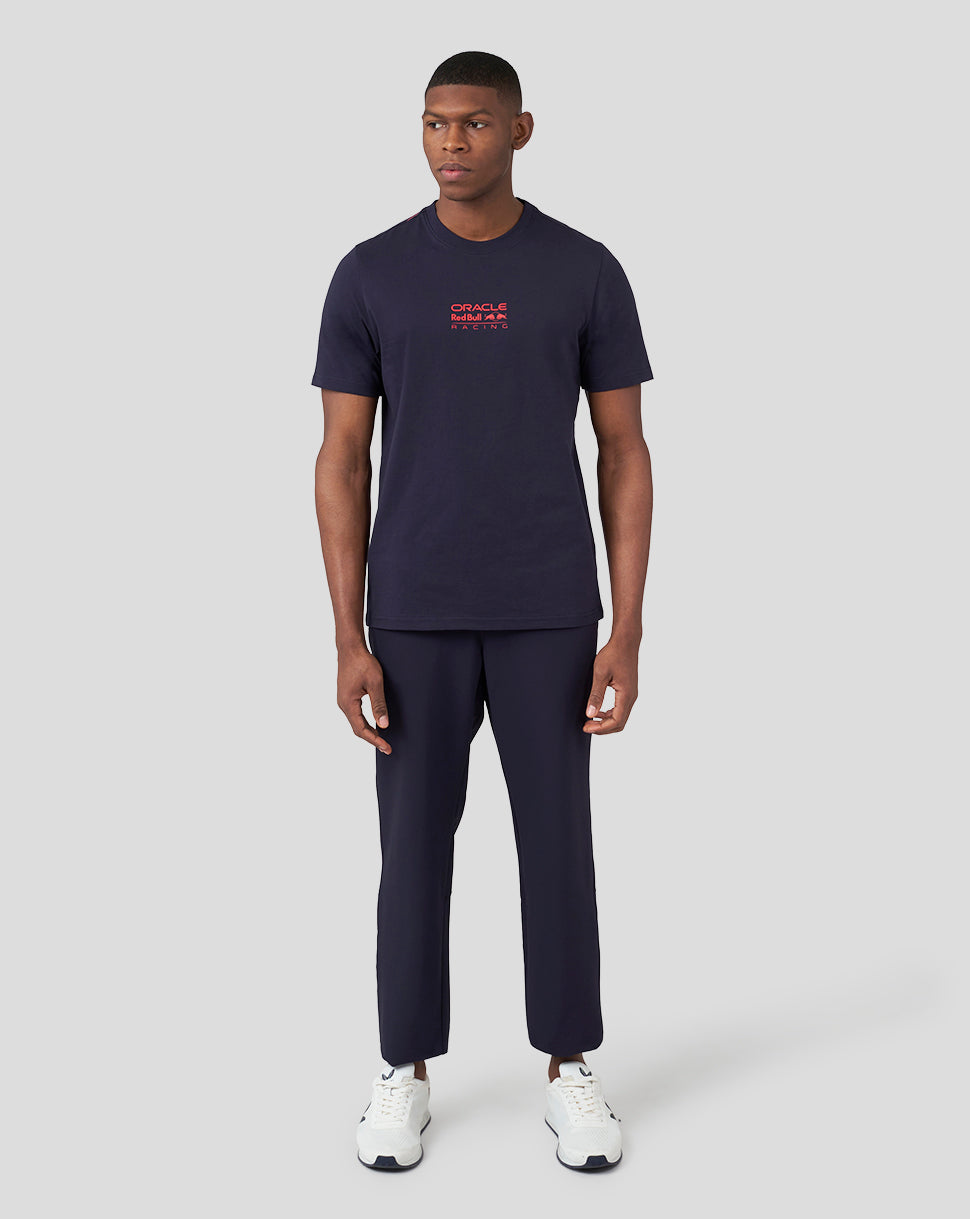 Front view of a man wearing a navy Oracle Red Bull Racing graphic T shirt with a small red logo on the chest.