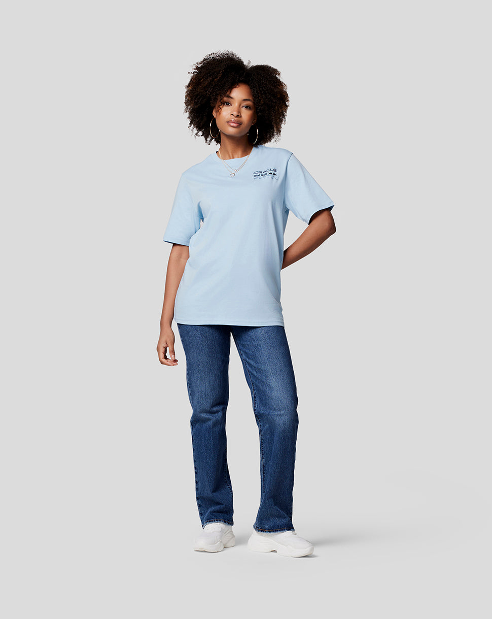 Female model in Dream Blue Oracle Red Bull Racing Core Tee with left chest logo and jeans