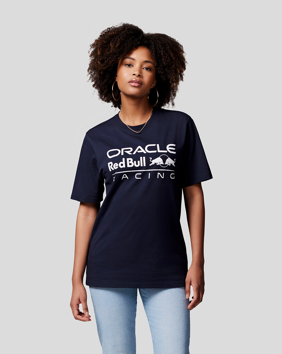 Portrait of a woman in a navy Oracle Red Bull Racing T shirt with a bold white front logo