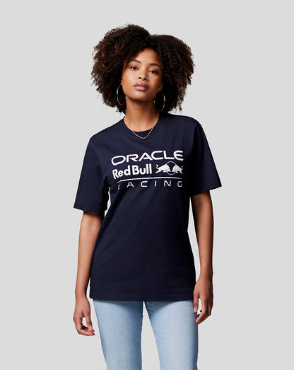 Portrait of a woman in a navy Oracle Red Bull Racing T shirt with a bold white front logo