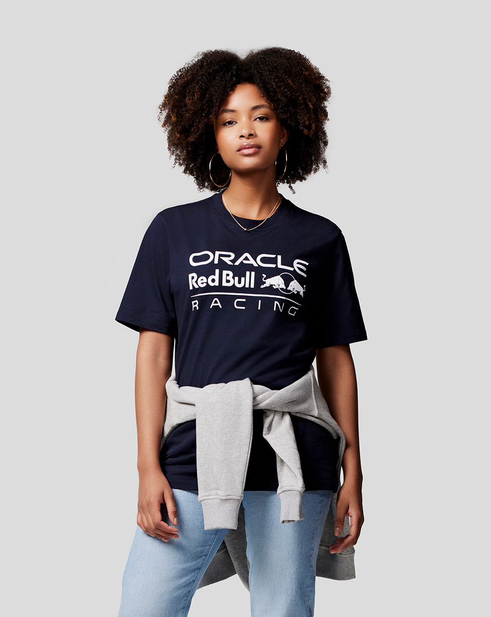 Model wearing navy Oracle Red Bull Racing large front logo T shirt with a light gray sweatshirt tied at the waist