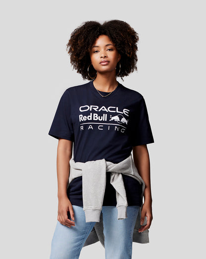 Model wearing navy Oracle Red Bull Racing large front logo T shirt with a light gray sweatshirt tied at the waist