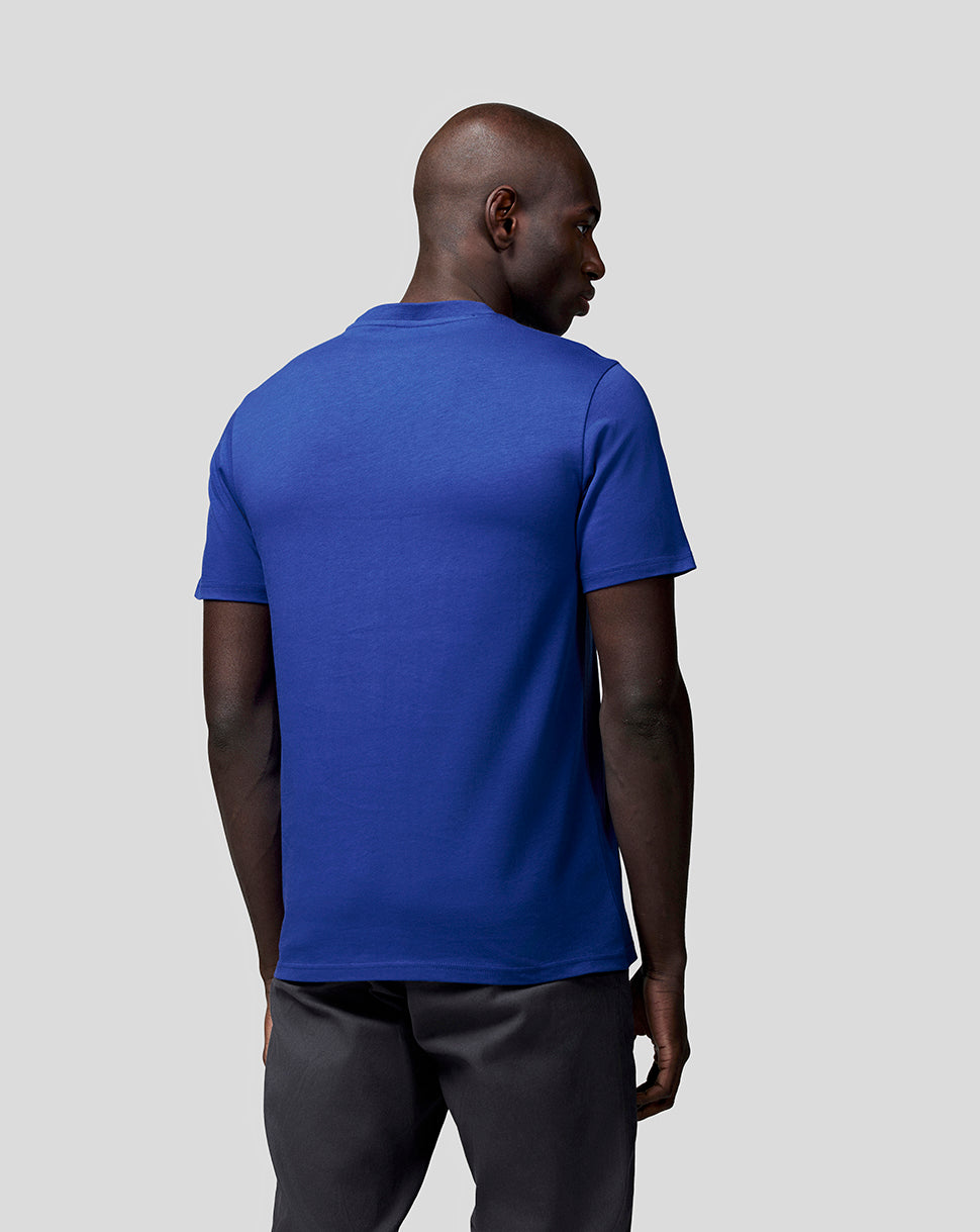 Back view of a man wearing a royal blue Oracle Red Bull Racing T shirt.