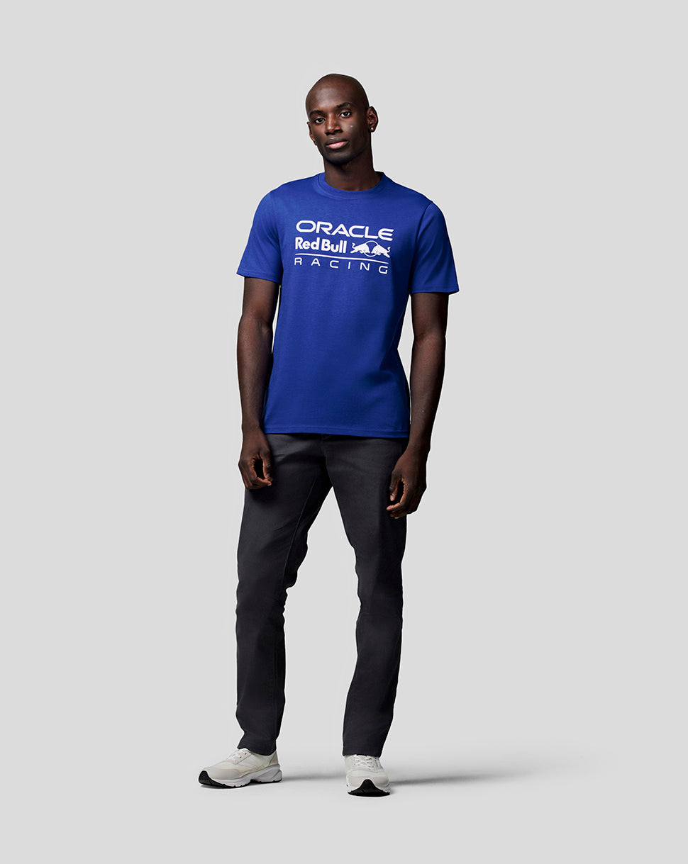 Front view of a model wearing a royal blue crew neck Oracle Red Bull Racing T shirt with a white logo on the chest
