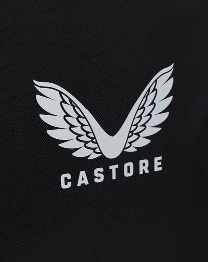 Close-up of white winged Castore logo on black bag fabric