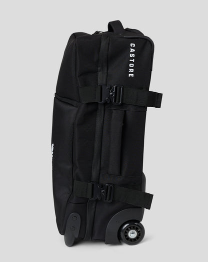 Side view of black small wheelie bag with adjustable strap and buckle and exposed wheel at base