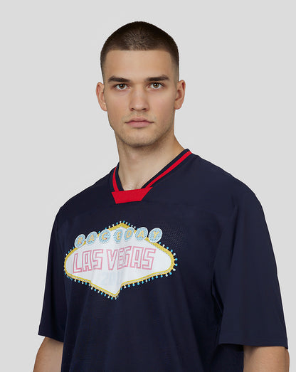 Close up of male model wearing navy Vegas American Football Jersey featuring Las Vegas sign graphic.