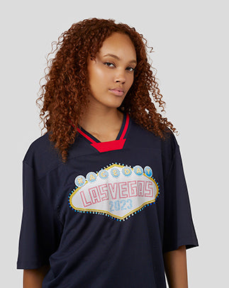 Female model in Oracle Red Bull Racing Vegas American Football Jersey with a Las Vegas graphic on the front.